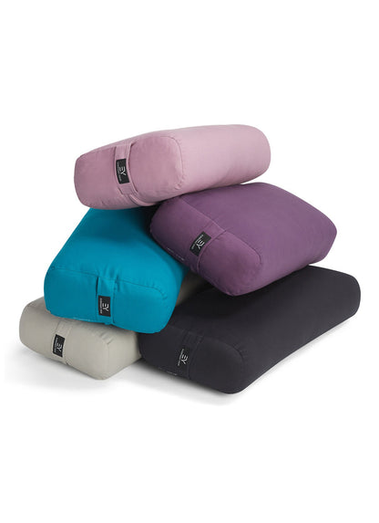 Everyday Yoga presents a collection of yoga bolsters in various colors, including pink, purple, teal, gray, and black, designed to enhance your yoga practice. These supportive props are perfect for restorative poses and meditation, ensuring comfort and stability. Ideal